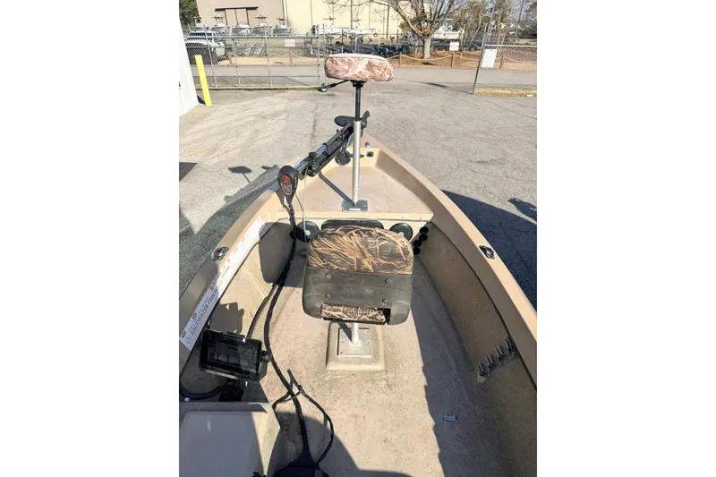 Slide: The Image of 2006 HIGH TIDE 15 boat interior with camouflage seat and steering controls. - 8