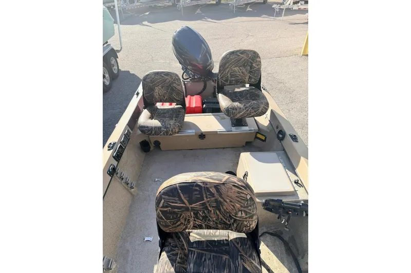 Slide: The Image of 2006 HIGH TIDE 15 boat interior with camouflage seats and motor. - 9