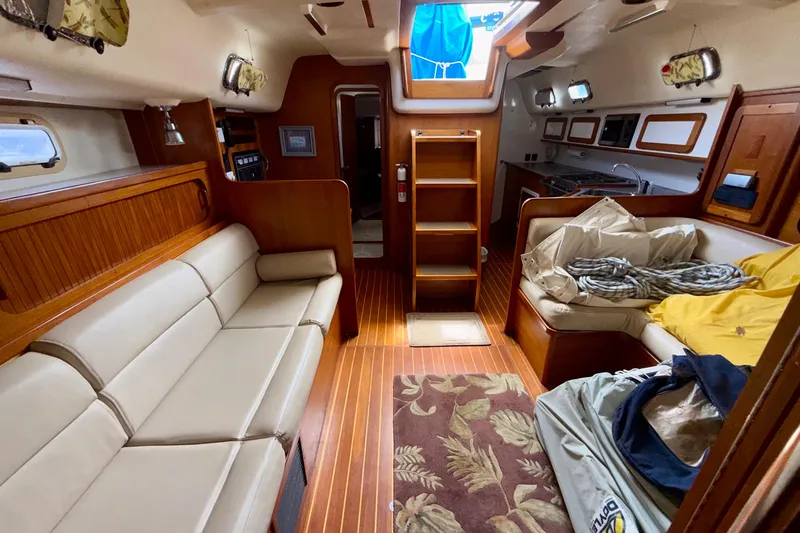 Slide: The Image of Interior of 2001 Caliber 47LRC yacht with cozy seating and wooden finishes. - 13