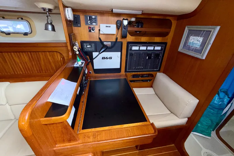 Slide: The Image of Navigation station inside a 2001 Caliber 47LRC yacht with control panels and seating. - 15
