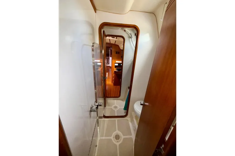 Slide: The Image of Interior of 2001 Caliber 47LRC yacht bathroom with wooden accents and shower. - 20