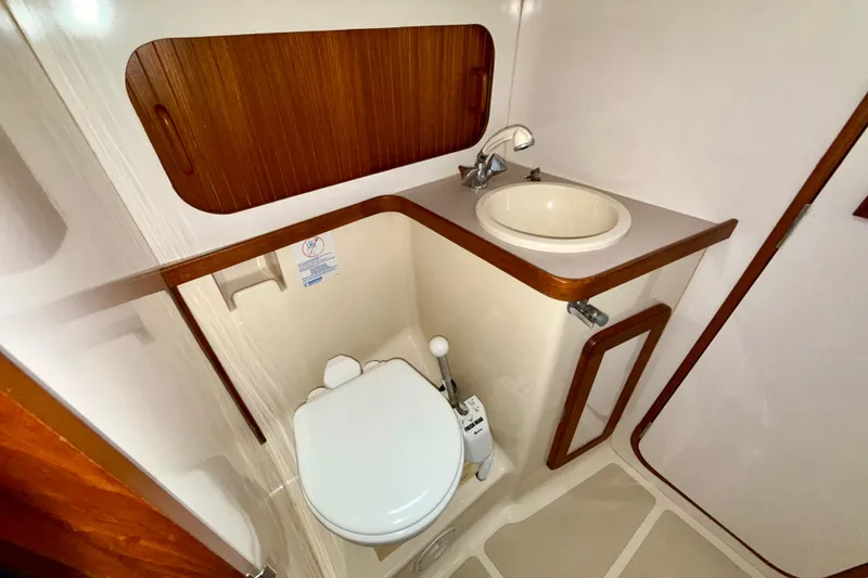 Slide: The Image of Compact bathroom in 2001 Caliber 47LRC yacht with sink and toilet. - 21