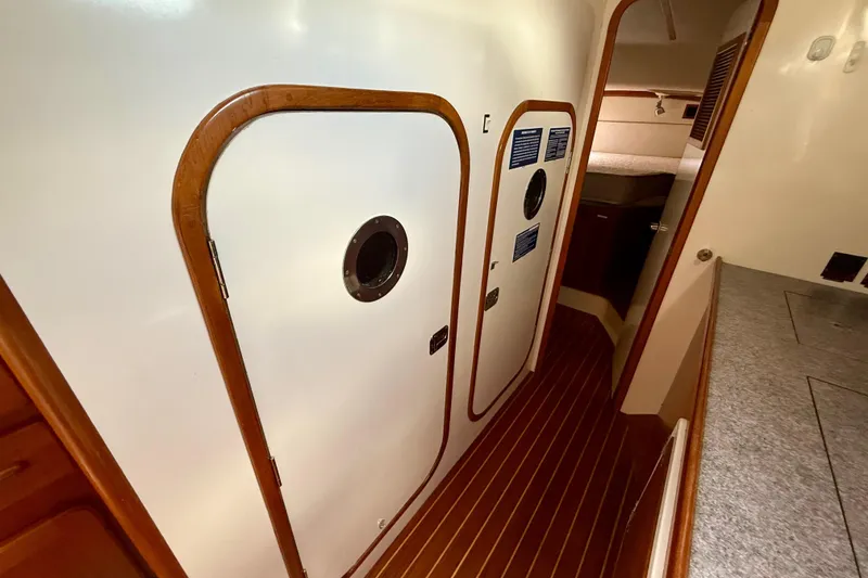 Slide: The Image of Interior of 2001 Caliber 47LRC yacht with wooden flooring and cabin doors. - 23