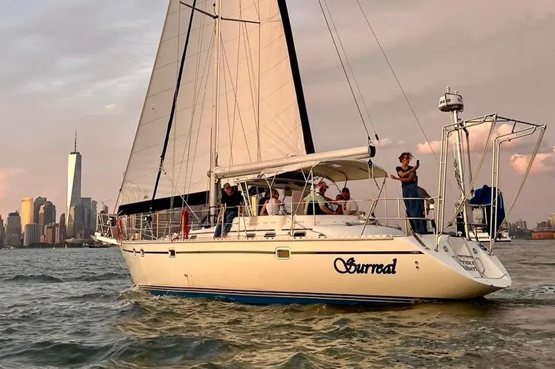 Slide: The Image of Sailboat Caliber 47LRC 2001 cruising near city skyline at sunset. - 24