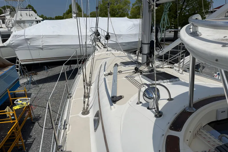 Slide: The Image of Sailboat deck of 2001 Caliber 47LRC in a boatyard, surrounded by other vessels. - 4