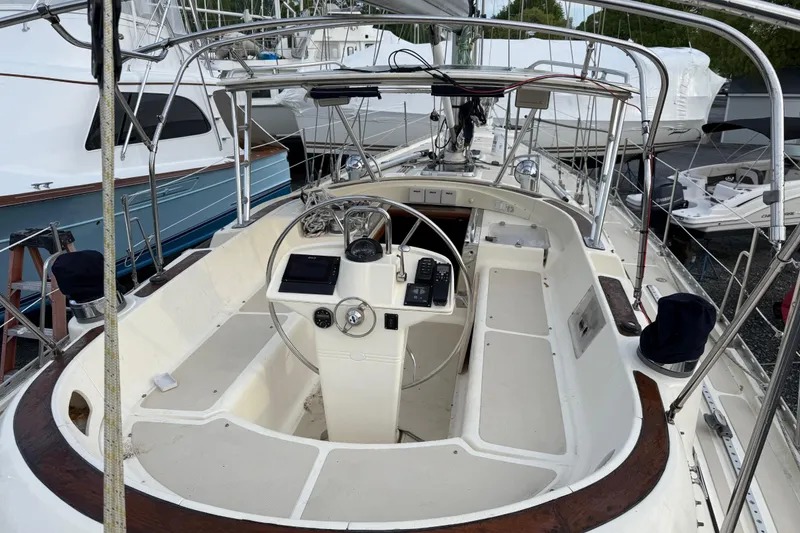 Slide: The Image of Cockpit of a 2001 Caliber 47LRC sailboat with steering wheel and navigation equipment. - 8