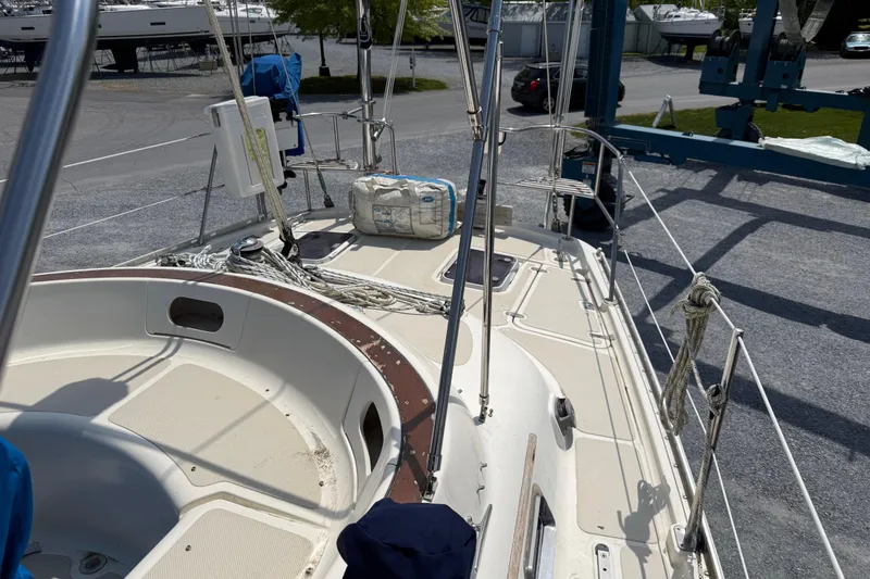 Slide: The Image of 2001 Caliber 47LRC sailboat deck view, featuring rigging and equipment in a marina setting. - 9