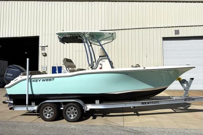 The Image of 2024 Key West 239 FS boat on trailer outside a warehouse. - 0