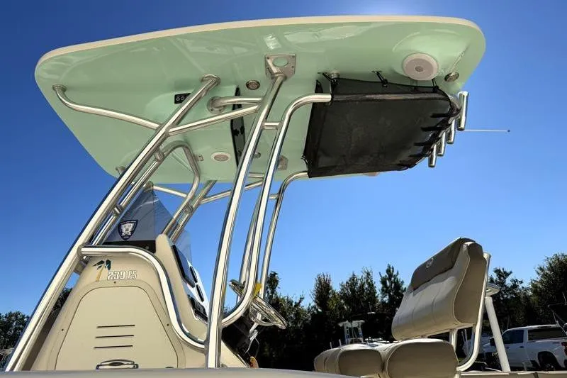 Slide: The Image of 2024 Key West 239 FS boat with T-top and seating, under clear blue sky. - 11