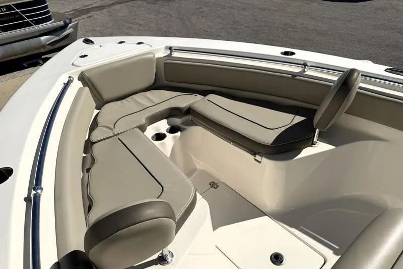 Slide: The Image of 2024 Key West 239 FS boat interior with cushioned seating and cup holders. - 13