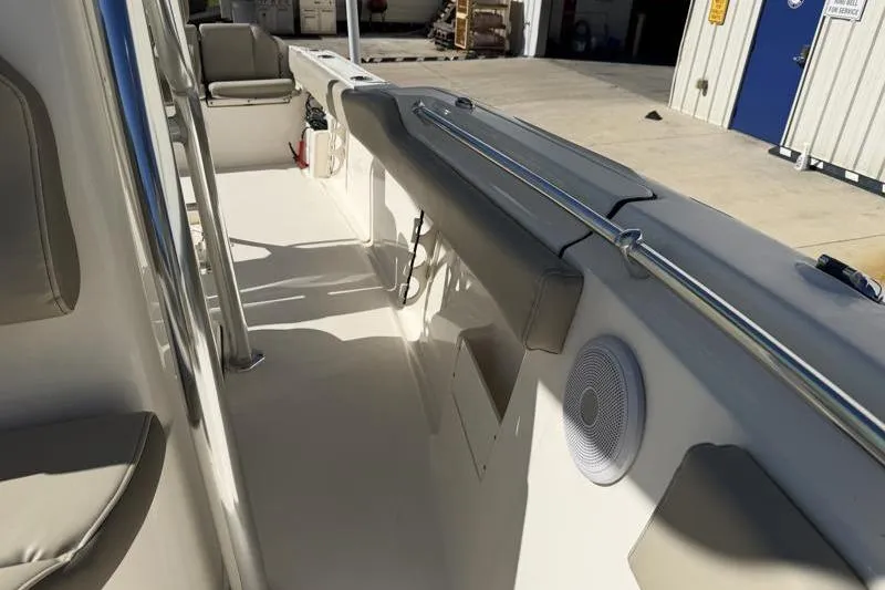 Slide: The Image of 2024 Key West 239 FS boat interior with seating and speaker. - 18