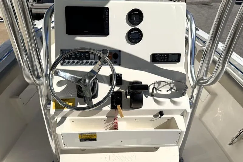 Slide: The Image of 2024 Key West 239 FS boat console with steering wheel and controls. - 21