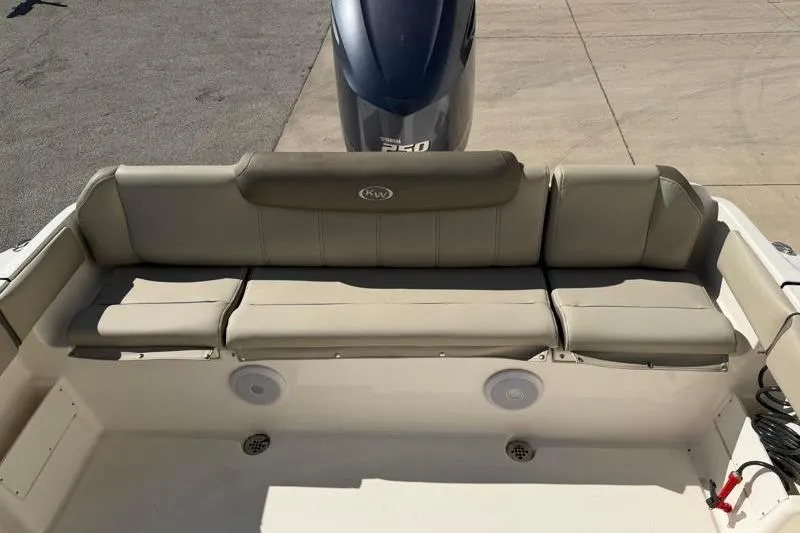 Slide: The Image of 2024 Key West 239 FS boat with cushioned seating and Yamaha 250 engine. - 29