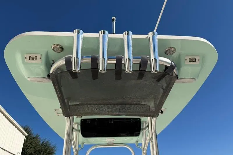 Slide: The Image of 2024 Key West 239 FS boat top view with rod holders against blue sky. - 31