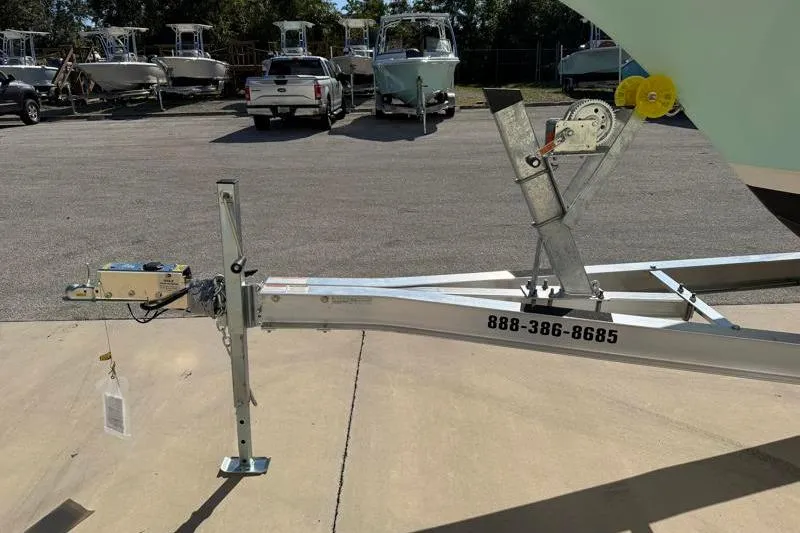 Slide: The Image of 2024 Key West 239 FS boat trailer with contact number, parked in a lot. - 36