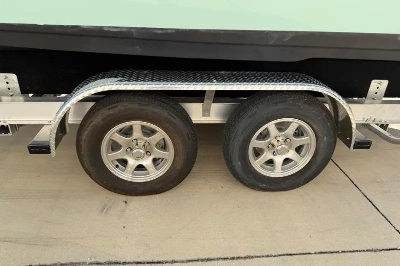 Slide: The Image of Trailer wheels of a 2024 Key West 239 FS boat on pavement. - 38