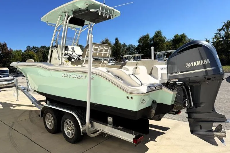 Slide: The Image of 2024 Key West 239 FS boat with Yamaha engine on trailer, outdoors. - 4