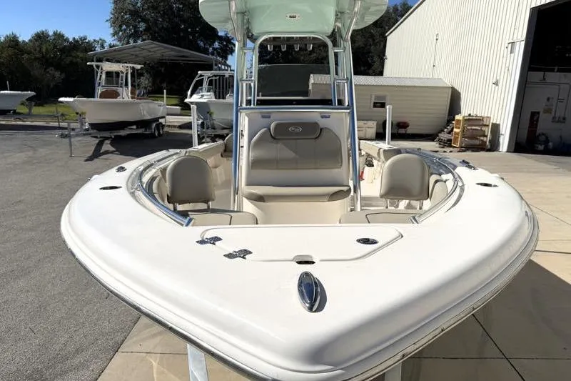 Slide: The Image of 2024 Key West 239 FS boat, white exterior, docked near a warehouse. - 5
