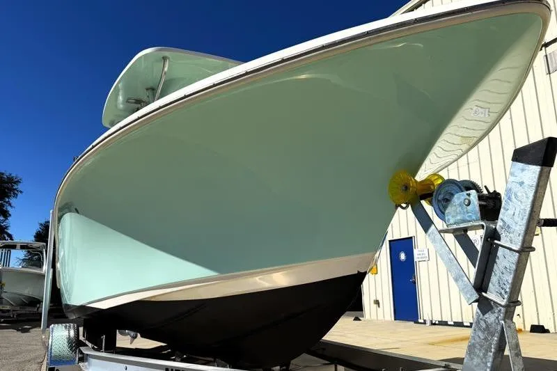 Slide: The Image of 2024 Key West 239 FS boat on trailer, displayed outdoors under clear blue sky. - 7