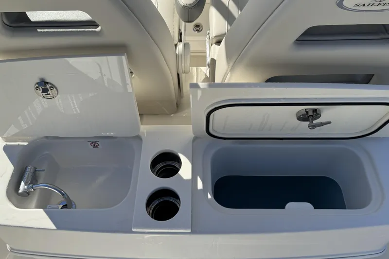 Slide: The Image of Sailfish 272 CC 2026 boat sink and storage compartments, open and ready for use. - 12