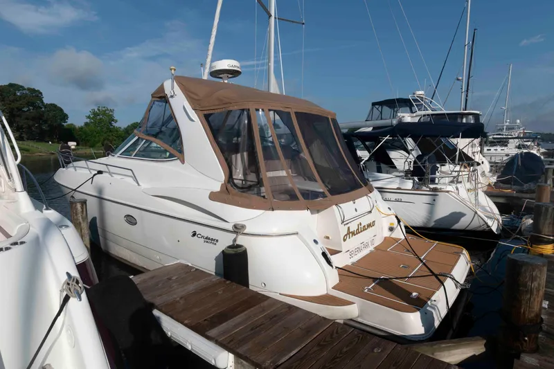 The Image of 2001 Cruisers Yachts 3672 Express docked at marina under clear blue sky. - 0