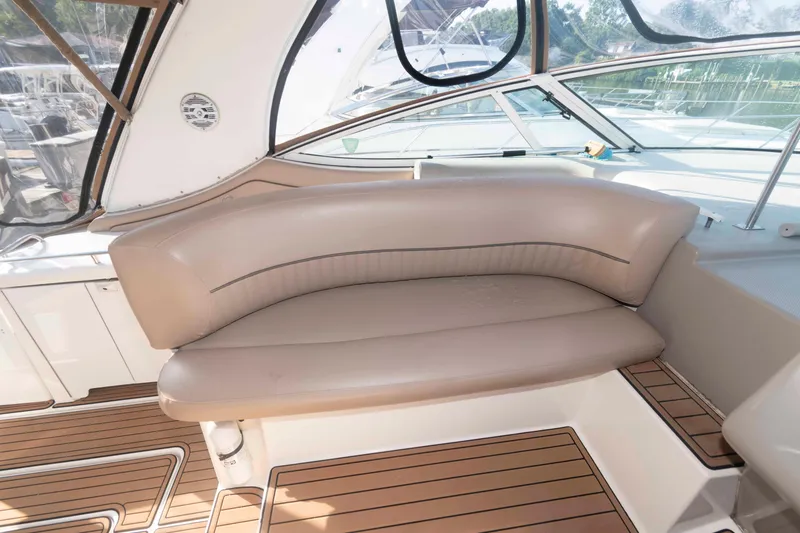 Slide: The Image of 2001 Cruisers Yachts 3672 Express interior with beige seating and wooden flooring. - 10