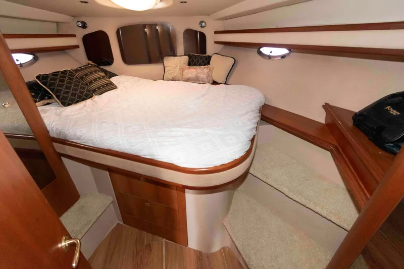 Slide: The Image of Luxurious cabin interior of 2001 Cruisers Yachts 3672 Express with cozy bed and elegant wood finish. - 15