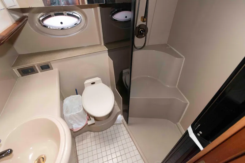 Slide: The Image of Bathroom interior of 2001 Cruisers Yachts 3672 Express, featuring shower and toilet. - 16