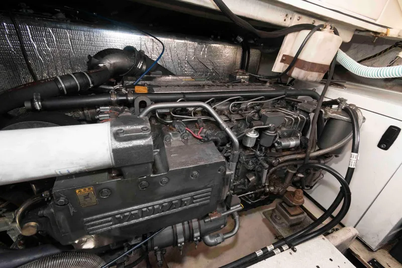 Slide: The Image of Engine compartment of a 2001 Cruisers Yachts 3672 Express, showcasing detailed mechanical components. - 18