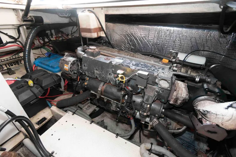 Slide: The Image of Engine compartment of 2001 Cruisers Yachts 3672 Express, showcasing mechanical components and wiring. - 19