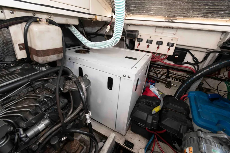Slide: The Image of Engine room of 2001 Cruisers Yachts 3672 Express, showcasing mechanical components and wiring. - 20