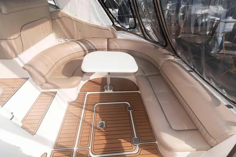 Slide: The Image of 2001 Cruisers Yachts 3672 Express interior with beige seating and wooden flooring. - 5