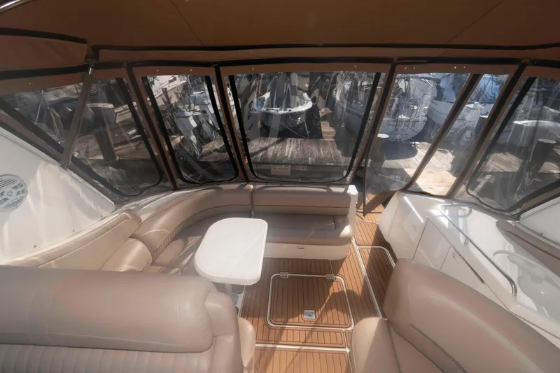 Slide: The Image of 2001 Cruisers Yachts 3672 Express interior with seating and table, featuring panoramic windows. - 6