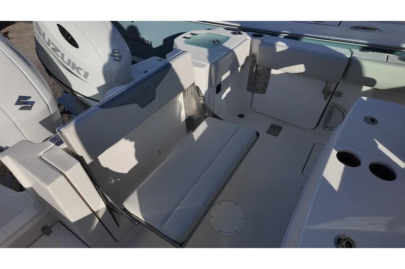 Slide: The Image of 2026 Sailfish 272 CC boat interior with Suzuki engines, featuring seating and storage compartments. - 12