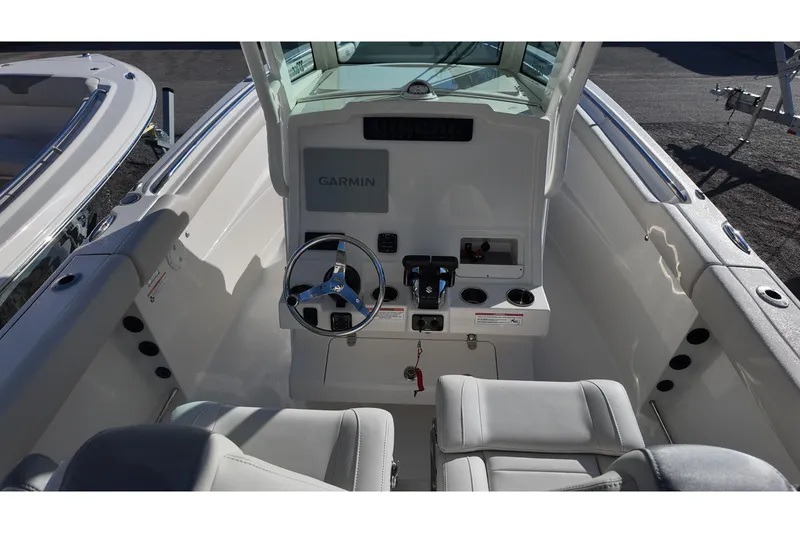 Slide: The Image of 2026 Sailfish 272 CC boat cockpit with Garmin navigation system and steering wheel. - 15