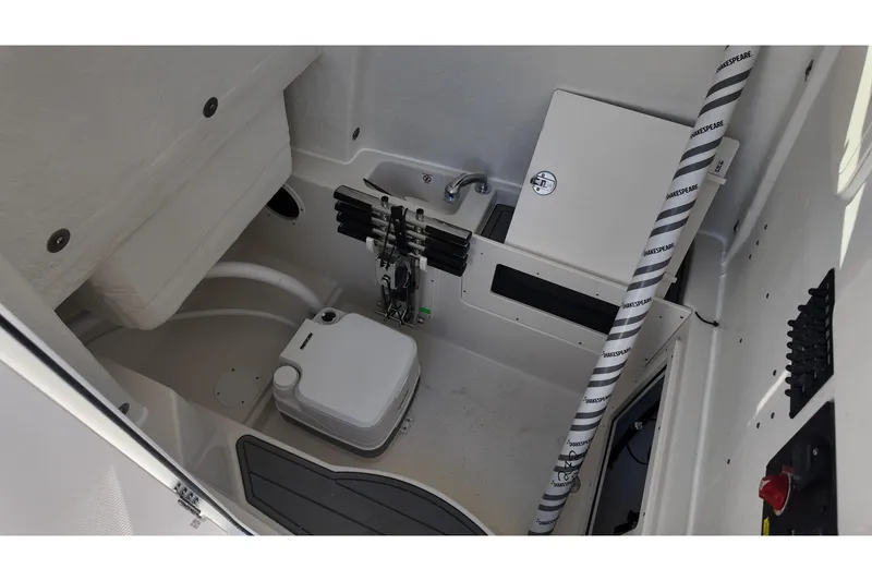 Slide: The Image of Interior of 2026 Sailfish 272 CC boat featuring compact toilet and storage area. - 16