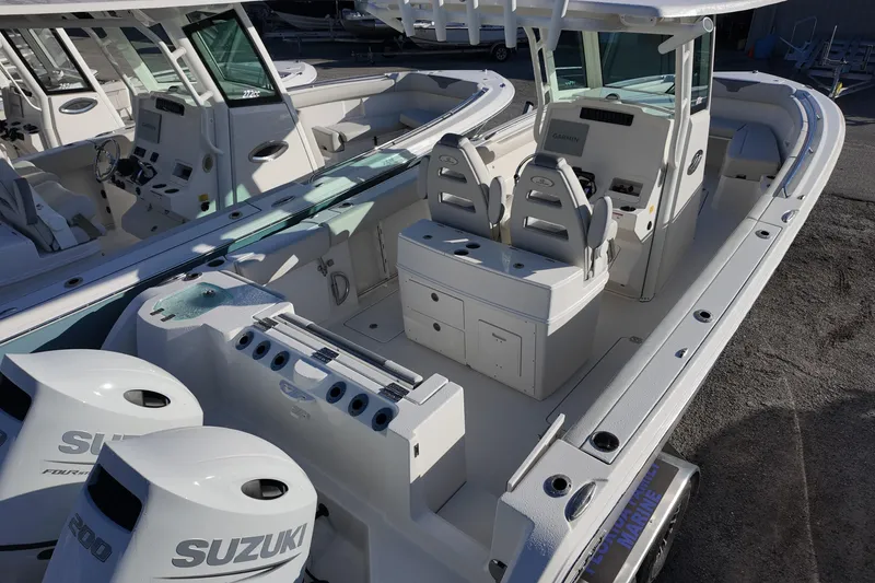 Slide: The Image of 2026 Sailfish 272 CC boat with dual Suzuki engines, spacious seating, and modern controls. - 4