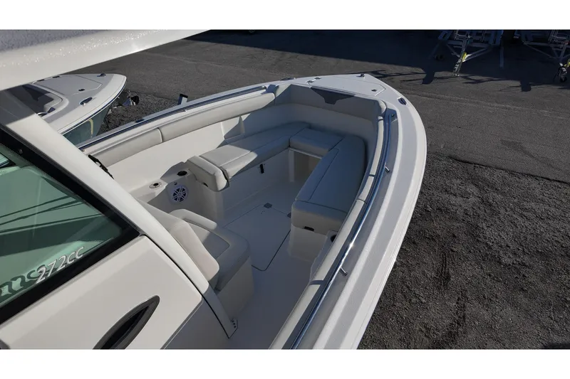 Slide: The Image of 2026 Sailfish 272 CC boat interior with cushioned seating and cup holders. - 6