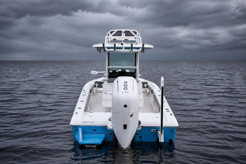 Slide: The Image of 2024 Everglades 253 Center Console boat on open water under stormy skies. - 10