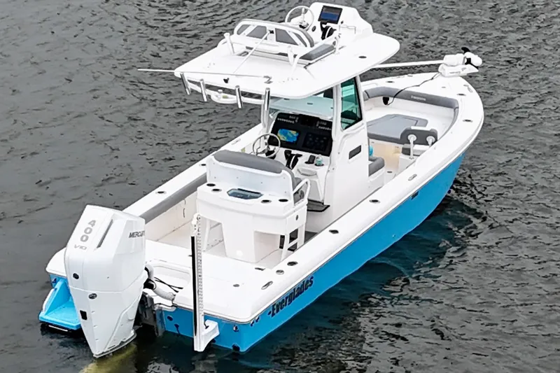Slide: The Image of 2024 Everglades 253 Center Console boat on water, featuring sleek design and powerful engine. - 13