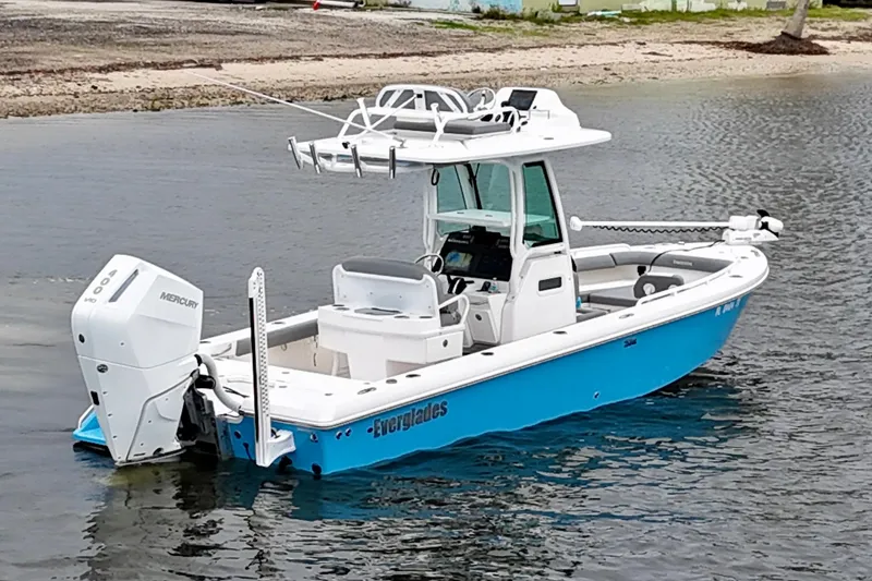 Slide: The Image of 2024 Everglades 253 Center Console boat on water, featuring sleek design and Mercury engine. - 16