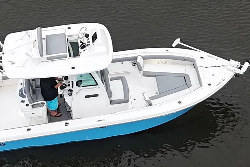 Slide: The Image of 2024 Everglades 253 Center Console boat on water, featuring spacious seating and modern design. - 20