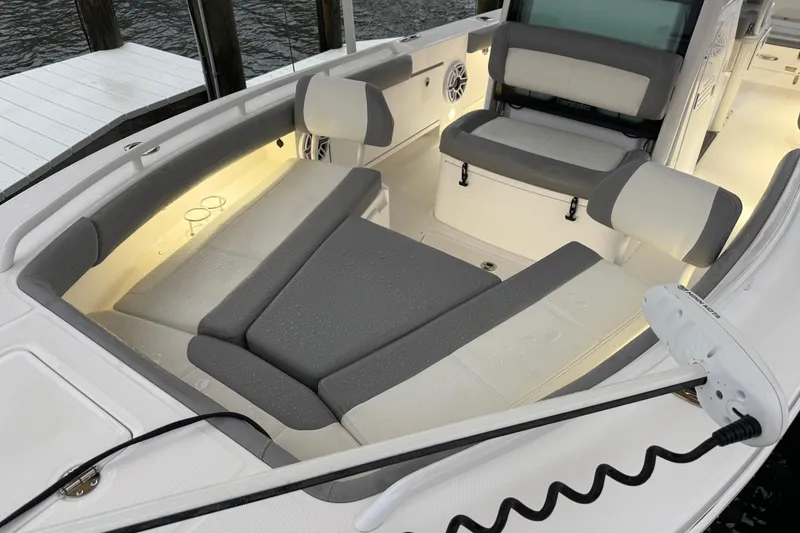 Slide: The Image of 2024 Everglades 253 Center Console boat interior with cushioned seating and ambient lighting. - 22