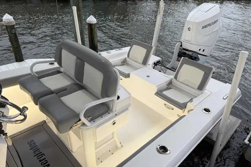 Slide: The Image of 2024 Everglades 253 Center Console boat with seating and Mercury engine at dock. - 24