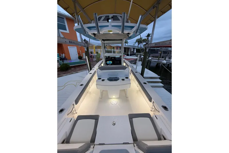 Slide: The Image of 2024 Everglades 253 Center Console boat with illuminated deck at dockside. - 25