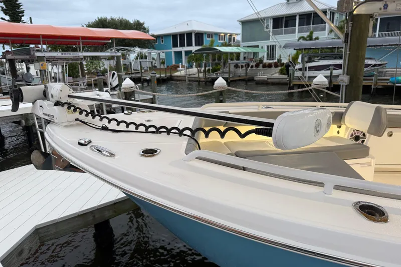Slide: The Image of 2024 Everglades 253 Center Console boat docked, featuring a Minn Kota trolling motor. - 26