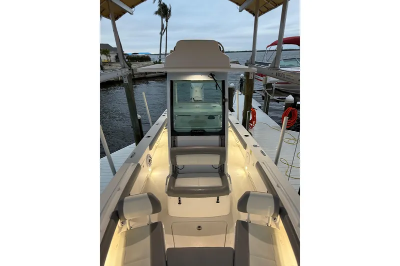 Slide: The Image of 2024 Everglades 253 Center Console boat docked, featuring illuminated seating and sleek design. - 28