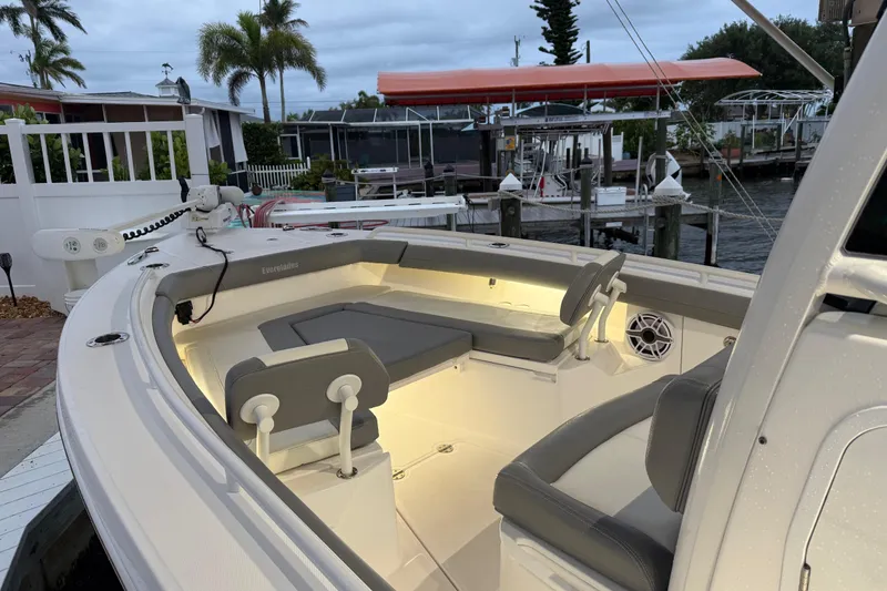 Slide: The Image of 2024 Everglades 253 Center Console boat with illuminated seating area at dockside. - 30