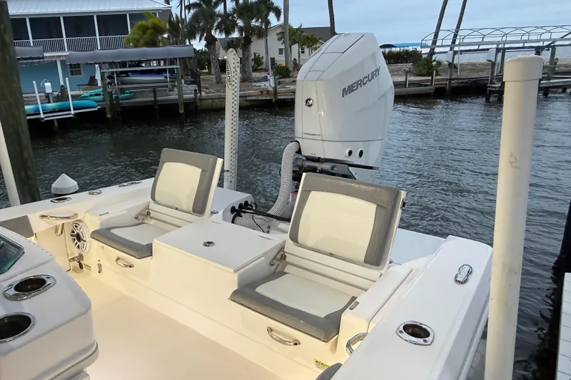 Slide: The Image of 2024 Everglades 253 Center Console boat with Mercury engine docked by waterfront homes. - 33