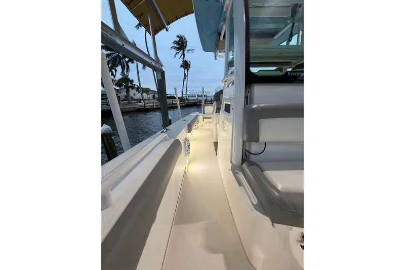 Slide: The Image of 2024 Everglades 253 Center Console boat docked, featuring sleek design and ambient lighting. - 34